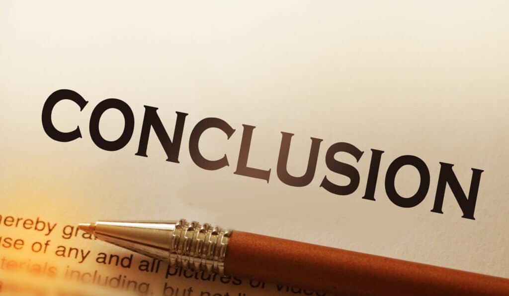 Zoomed into a piece of paper, with the word conclusion as a header. With text underneath and a pen lying overtop.
