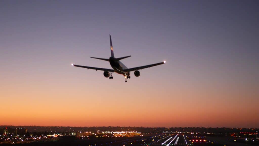 Airport runway lights at night, plane or airplane landing to airstrip.