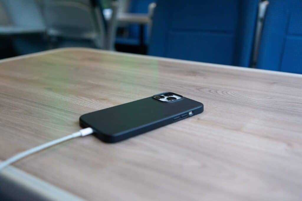 Phone screen facing down on a table.