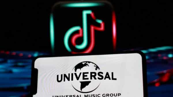 Universal logo projected in an iPhone screen infront of a TikTok logo