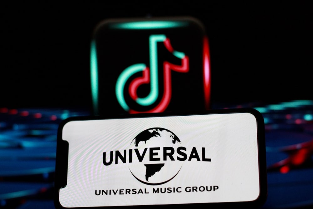 Universal logo projected in an iPhone screen infront of a TikTok logo