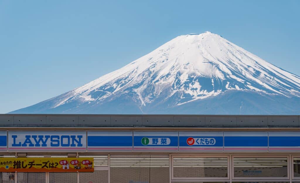 Yamanashi, Japan - April 10, 2023 - Lawson Kawaguchiko Station with Mount Fuji in the background.