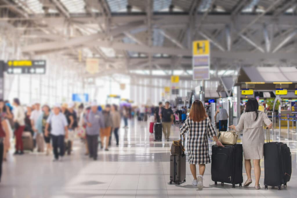 Woman carries luggage at the airport terminal.