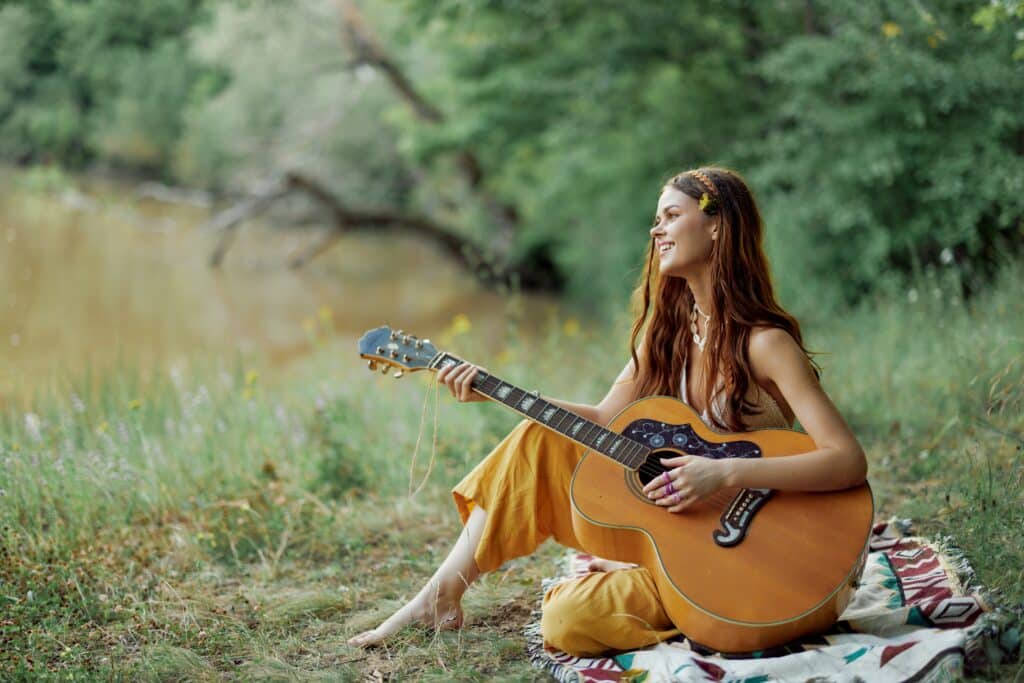Woman with guitar singing in nature