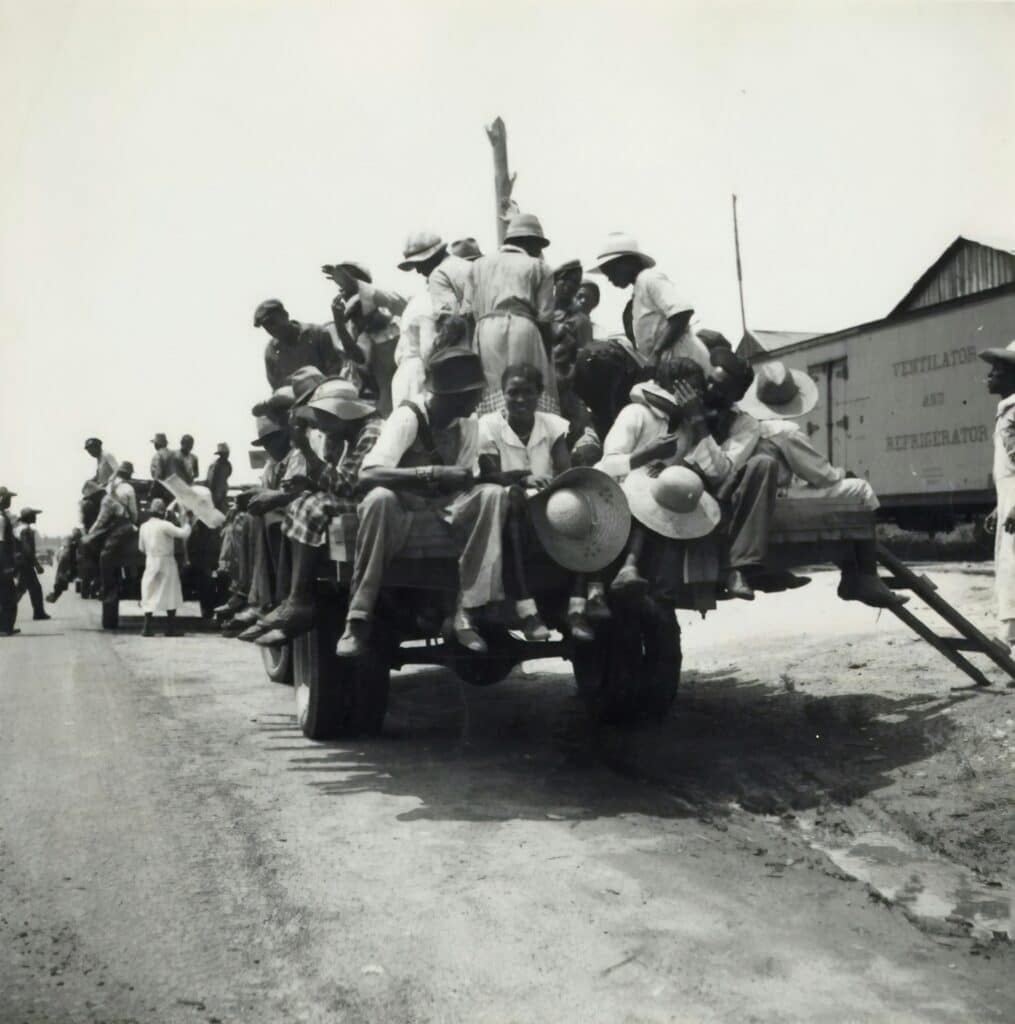 Peach pickers being driven to the orchards. They earn seventy-five cents a day. Muscella, Georgia.