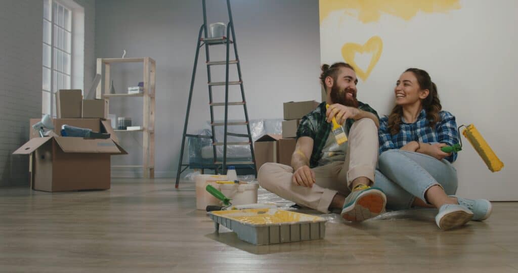 young couple buying home after investing and budgeting their finances