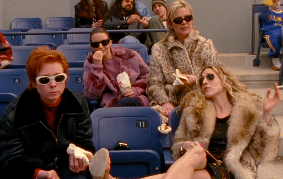 Carrie, Miranda, Samantha, and Charlotte from Sex and the City watch a baseball game together while discussing sex and relationships.