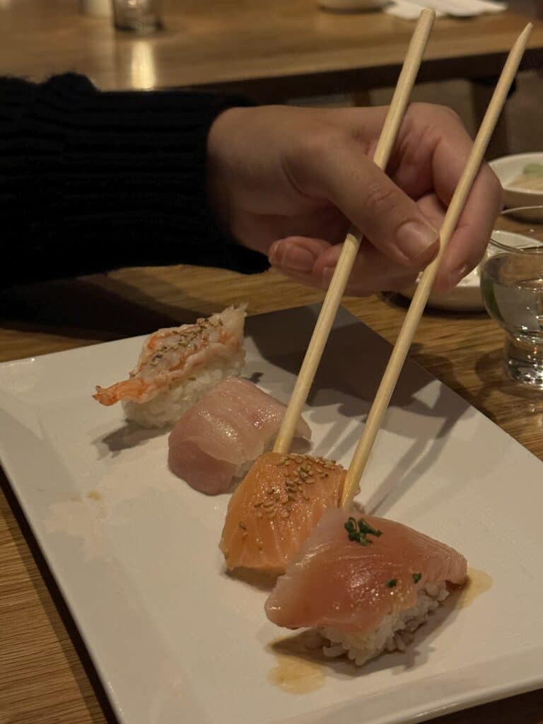 Image of four types of nigiri. Fish atop a ball of rice