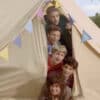 Harry, Louis, Liam, Zayn and Niall in a tent in the video ‘Live While We’re Young’.