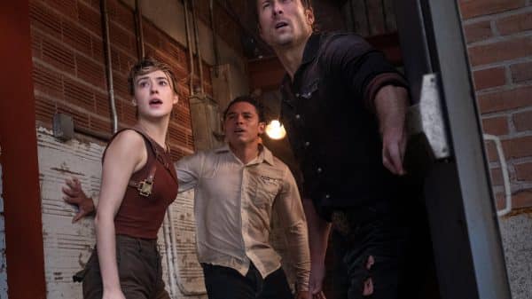 Kate (Daisy Edgar Jones), Tyler (Glen Powell) and Javi (Anthony Ramos) all take shelter inside an old cinema as the look outside to see the incoming storm