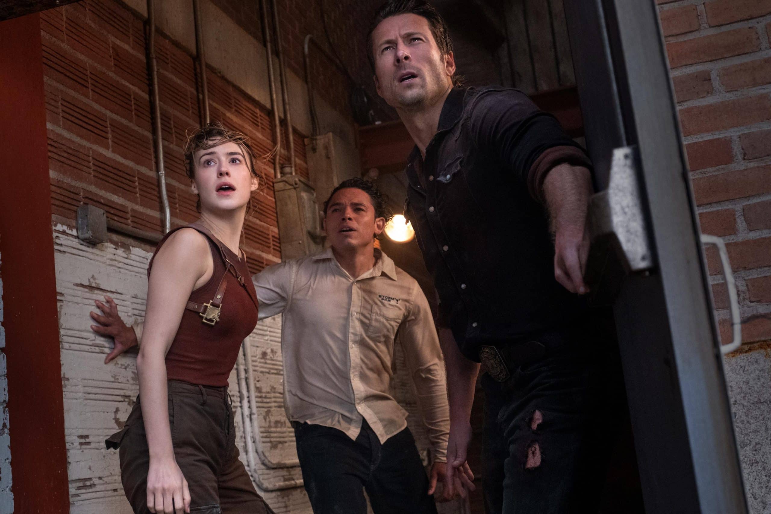 Kate (Daisy Edgar Jones), Tyler (Glen Powell) and Javi (Anthony Ramos) all take shelter inside an old cinema as the look outside to see the incoming storm