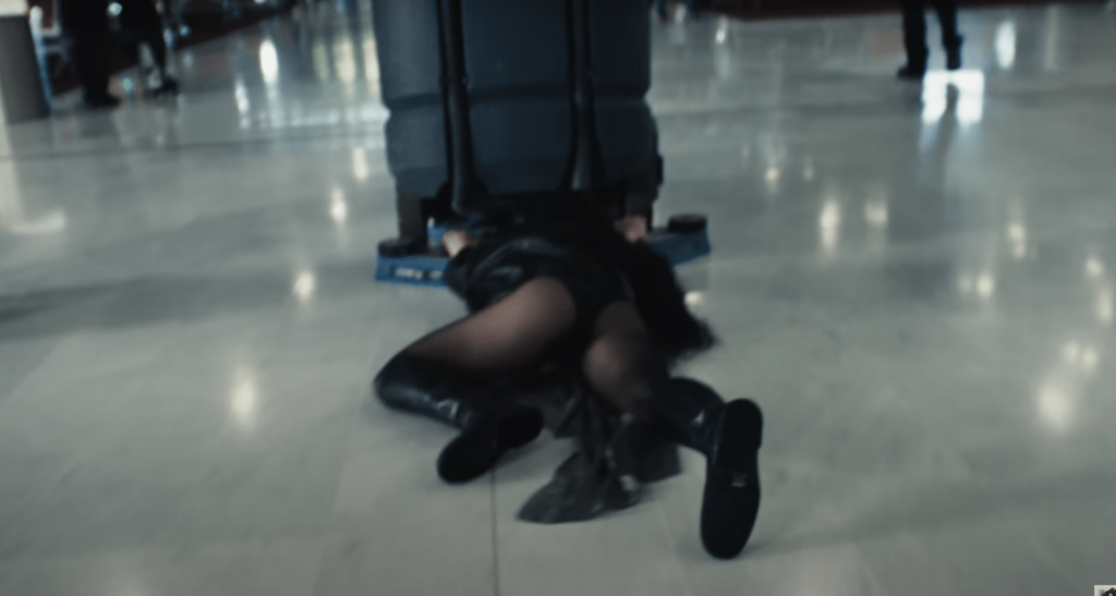 A screenshot of Charli Xcx being dragged by a machine in the music video for "Von Dutch".