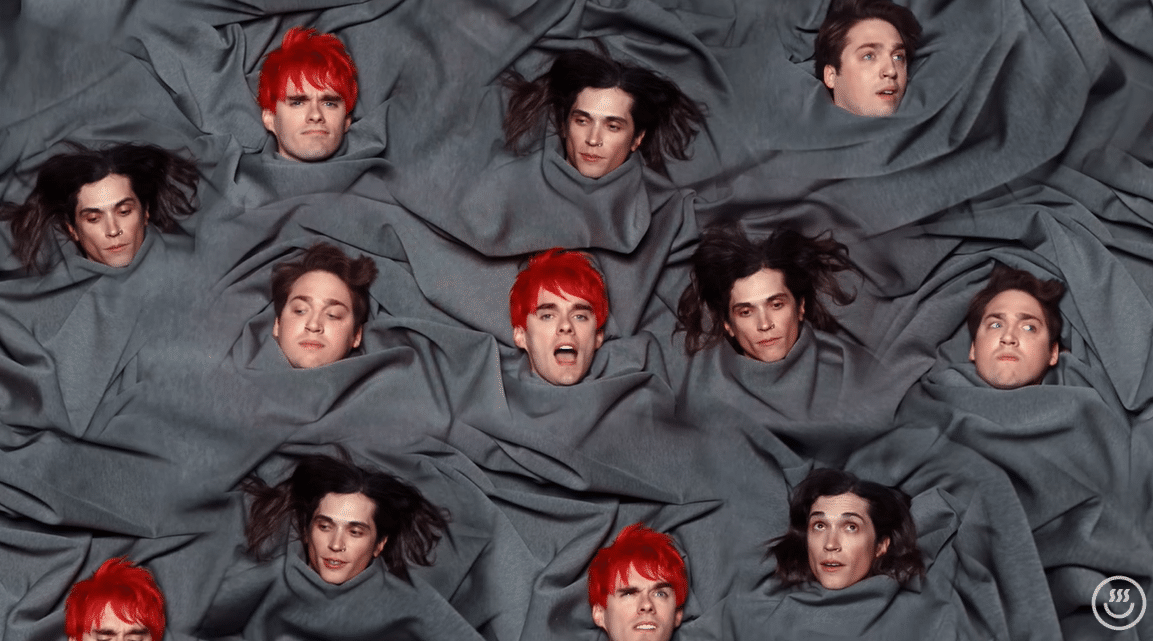 Clip of FUNERAL GREY music video with multiple Awsten, Otto, and Geoff heads on a grey sheet