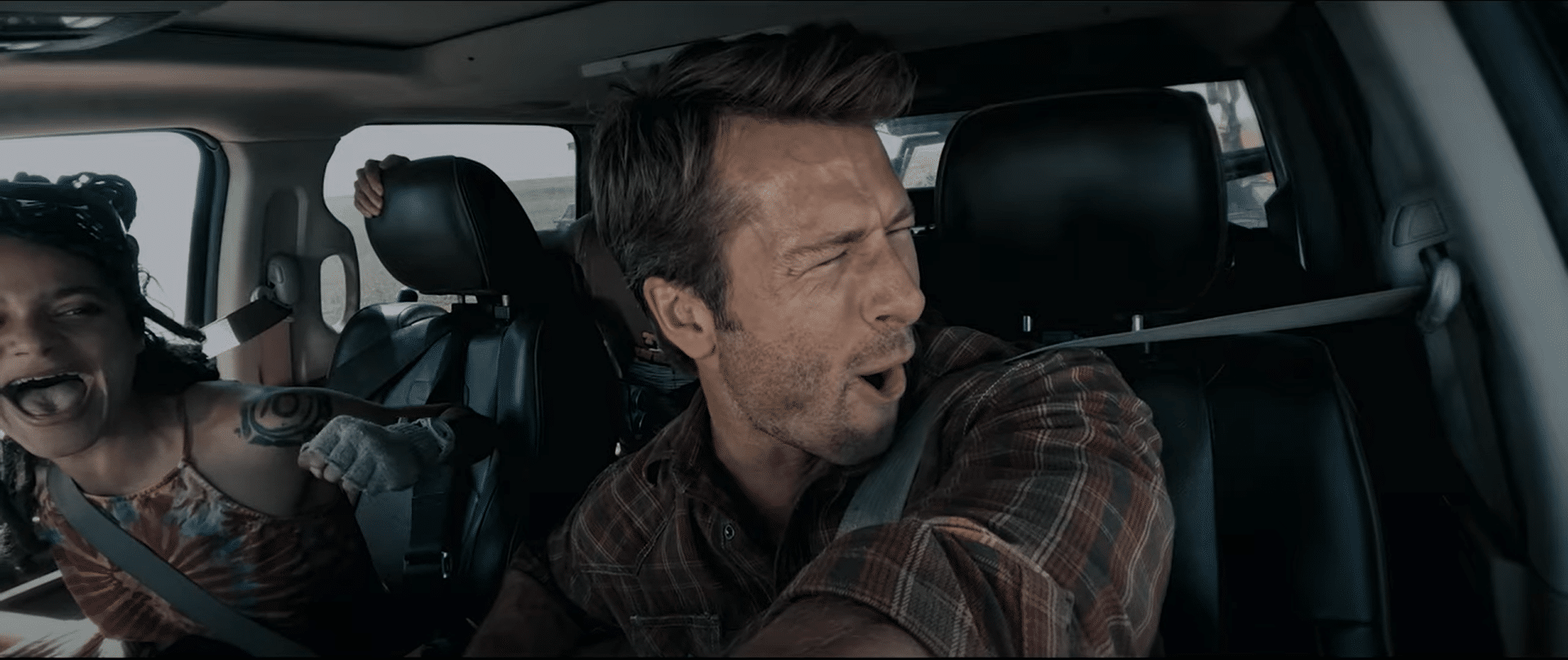 From left to right: Sasha Lane and Glen Powell "wrangling" a tornado. Credit: YouTube/ONE Media +