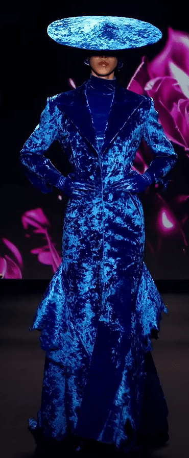 A satin blue dress on a runway.