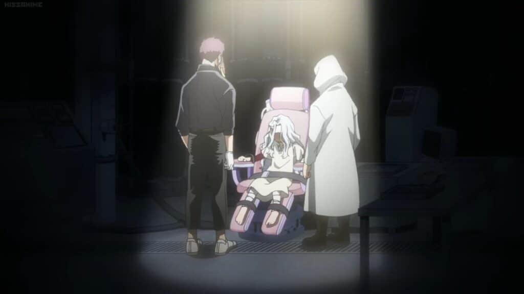 Eri sits tied to a dentist chair while overhaul and a man in a white cloak stand over her in the spotlight. Her arms are bleeding!