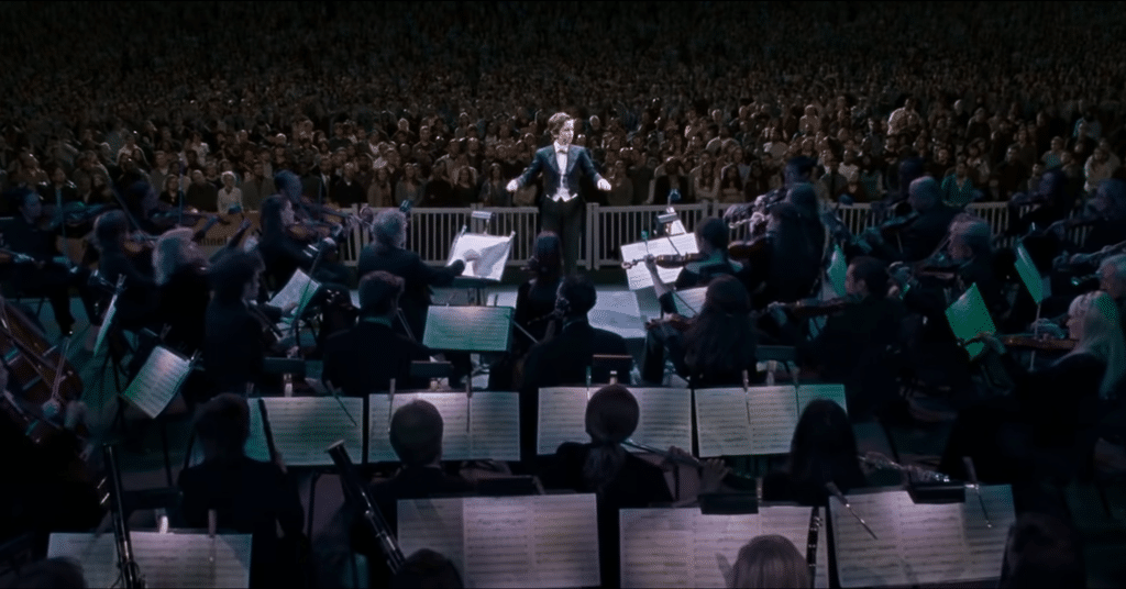 boy is conducting a concert.