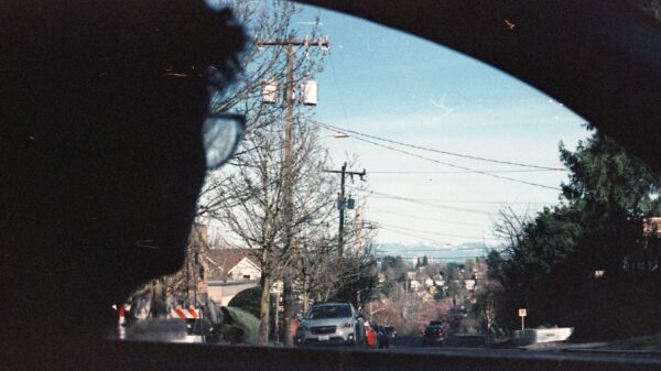A man looks out the window of a car towards Seattle's Mount Rainier