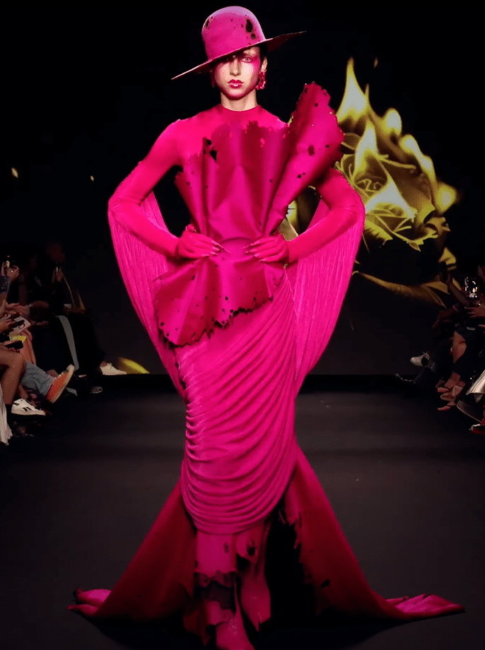A hot pink dress on a runway.