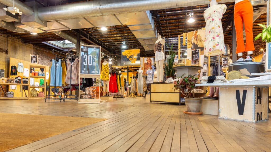 A wide view of an Urban Outfitters store layout emulating a thrift store aesthetic.