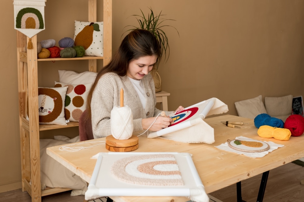 Young woman doing needlepoint. A hobby to make an effective CV.