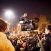 A camera films a protest.