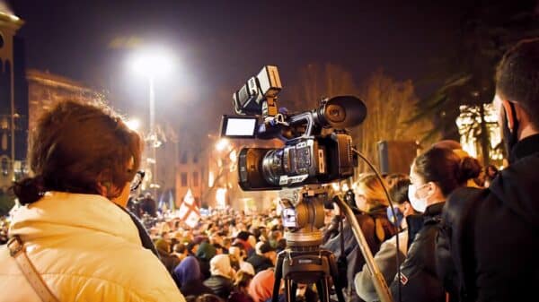 A camera films a protest.