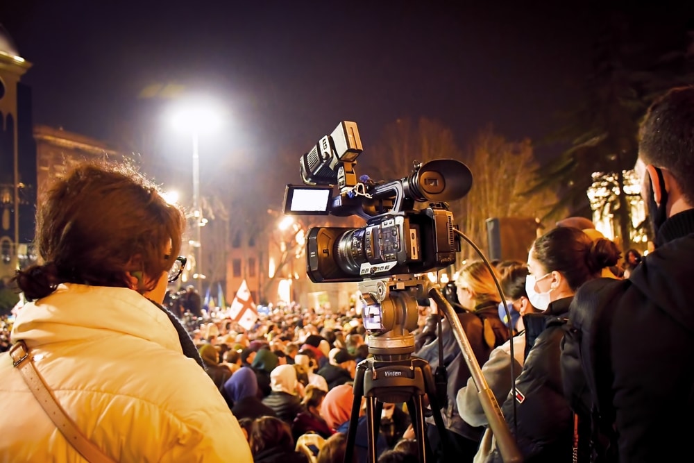 A camera films a protest.