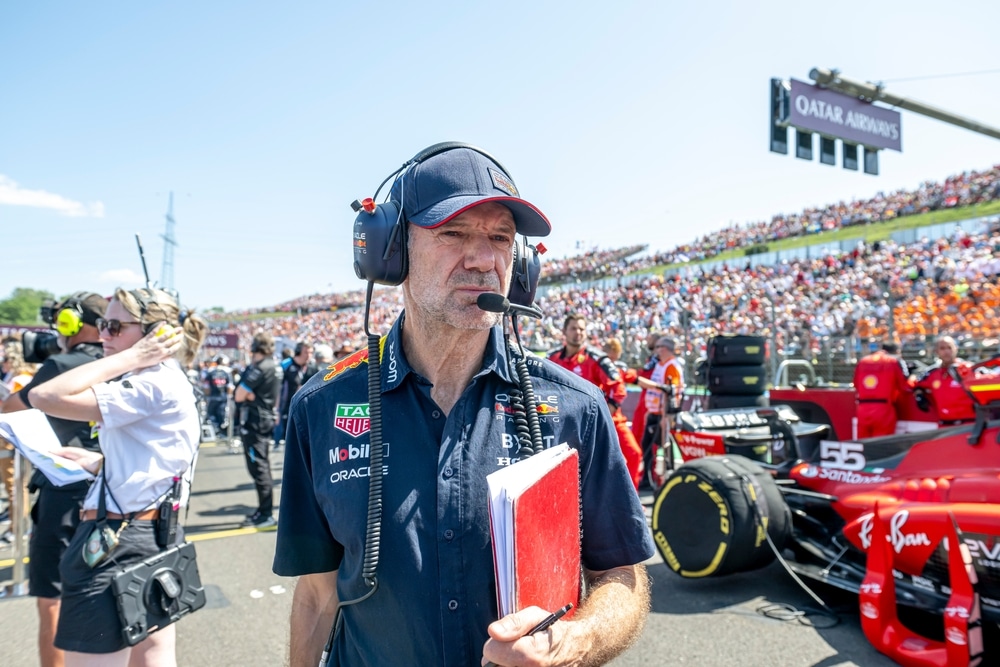 Adrian Newey on the grid with his notebook.