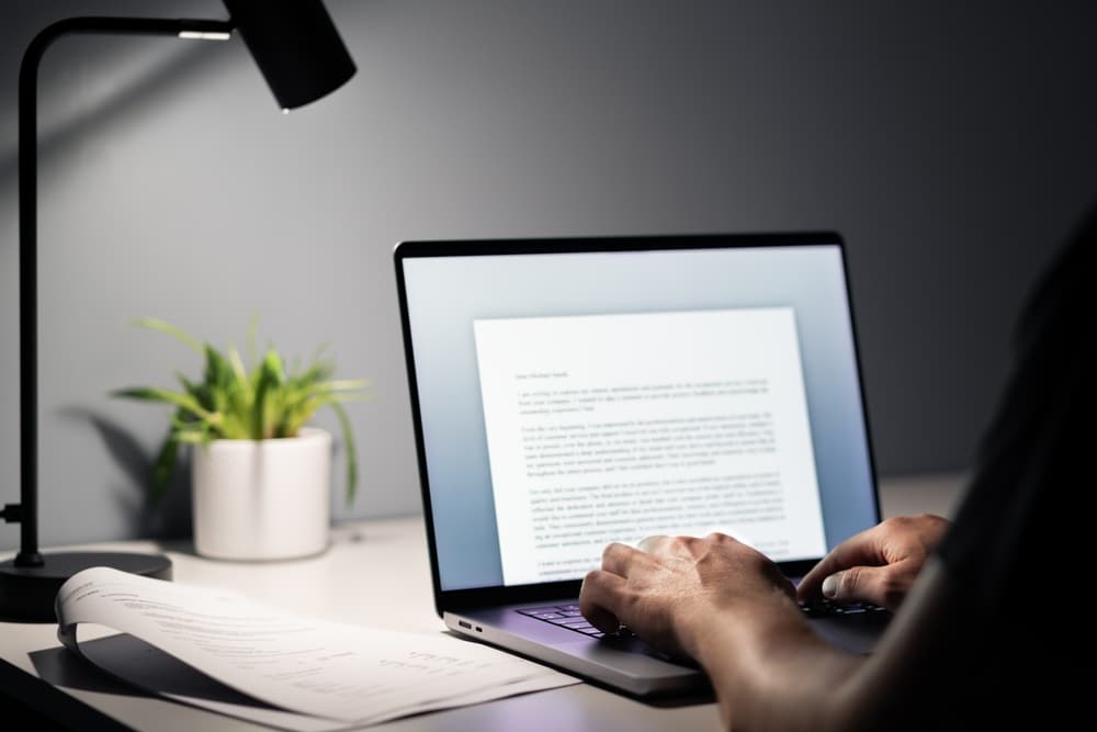 A man writing a text document. Can add to his CV to make it more Effective.