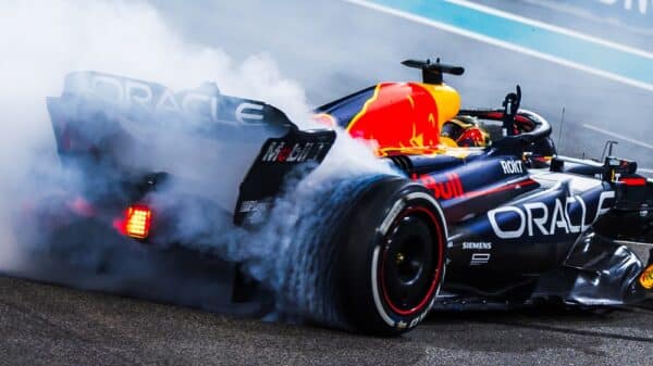Max Verstappen's car releasing smoke from the rear in the 2023 Abu Dhabi Grand Prix