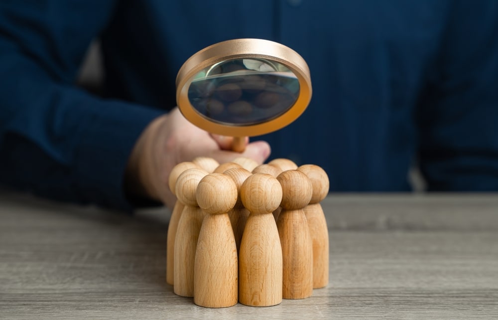 person observing people under microscope