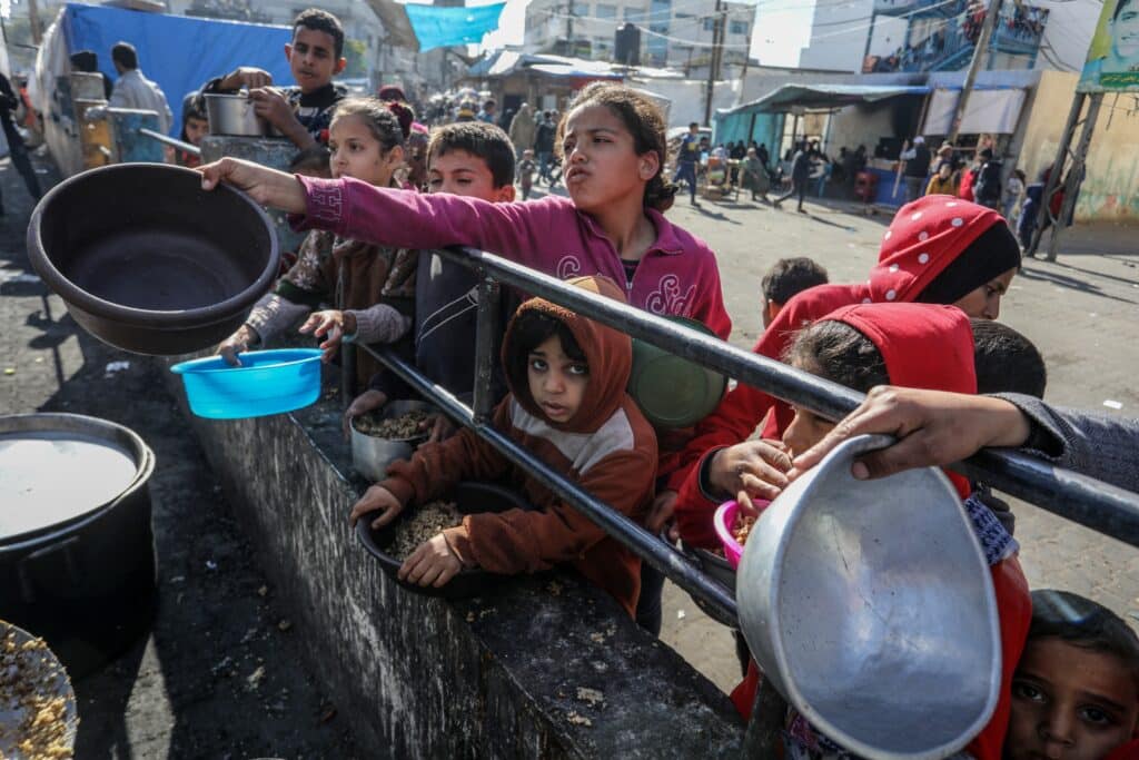 A charity organization distributes food, “Takiya,” to displaced Palestinians in the Gaza Strip.