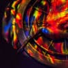 Hunger Games mocking jay symbol in red, green, and blue lighting.