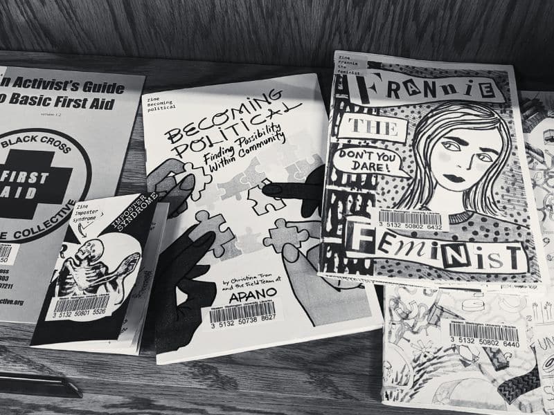A library display of zines. One is titled "France the Feminist."