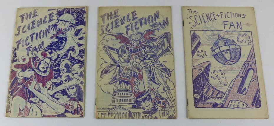 A flatlay of three science fiction zines from the 1930s. They are word from age and drawn in what looks like blue pen.