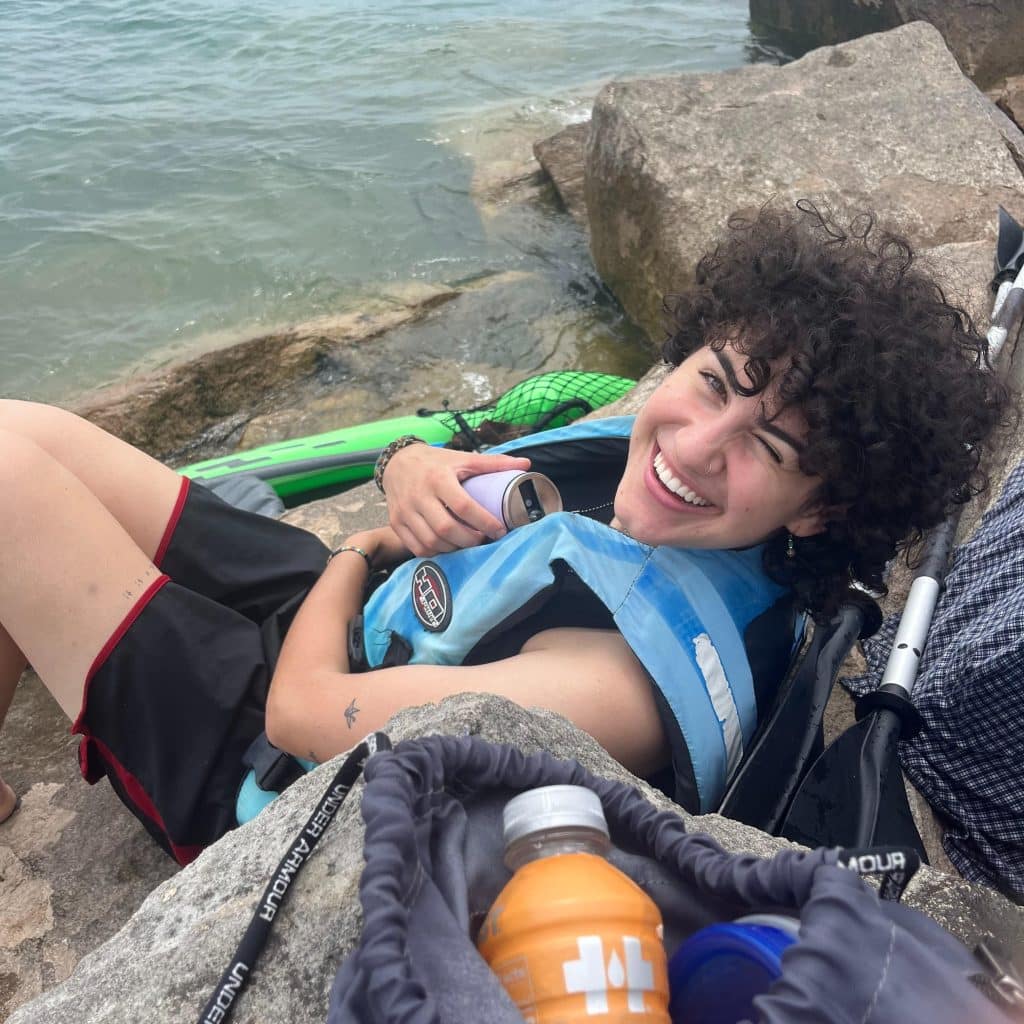 A photo of my friend Tessa after we kayaked to Chicago to show all the ways you can find adventure