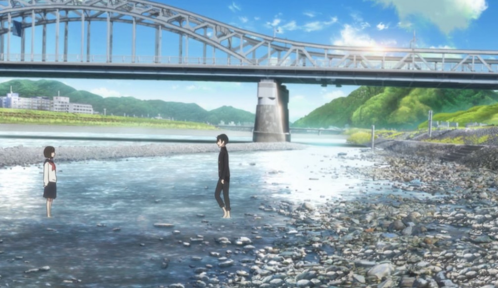 Two highschoolers Osanai and Kobato step into a shallow river full of rocks. A metal bridge hangs overhead in the background.