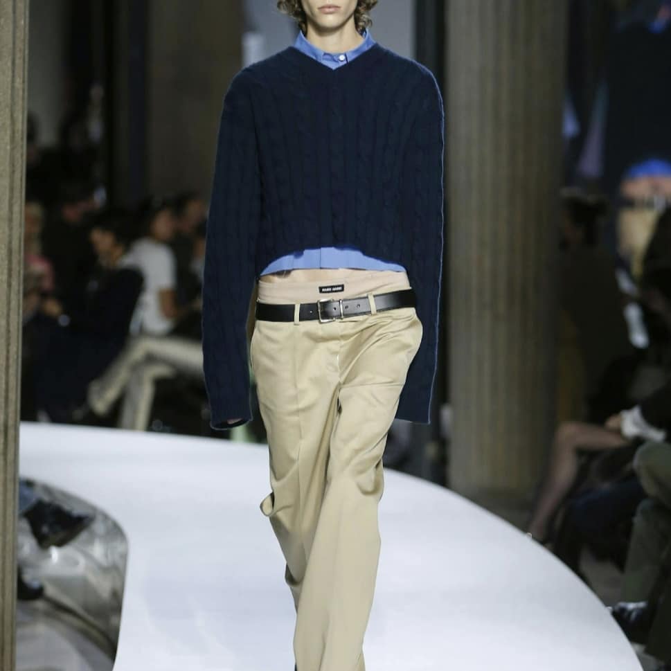Miu Miu model in a navy blazer and tan pants