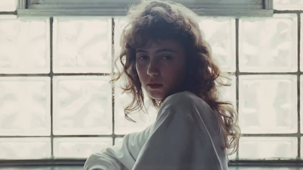 A screenshot of Clairo posing in the "Juna" music video.