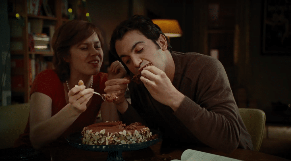 man and woman eating cake