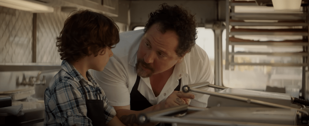 man is in food truck with his son.