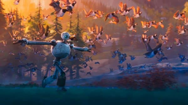 Robot running through field with birds.