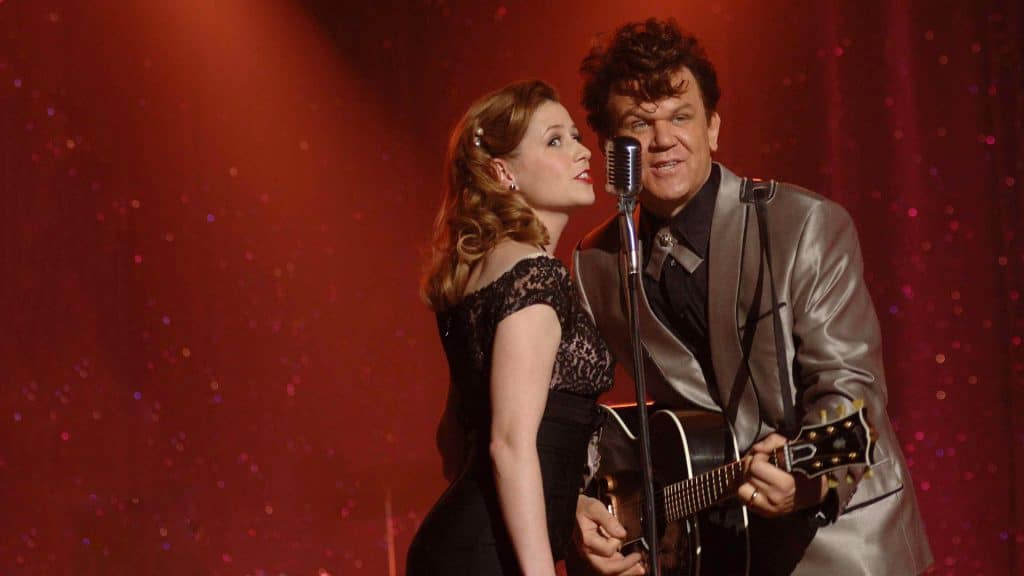 Dewey Cox (John C. Reilly) and Darlene (Jenna Fischer) performing together.