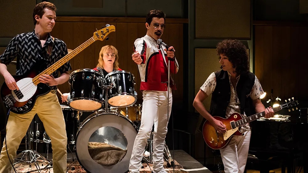 The band Queen (Joseph Mazzello, Ben Hardy, Rami Malek, and Gwilym Lee from left to right) at the recording studio.