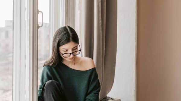 Young busy woman working from home in sweatpants