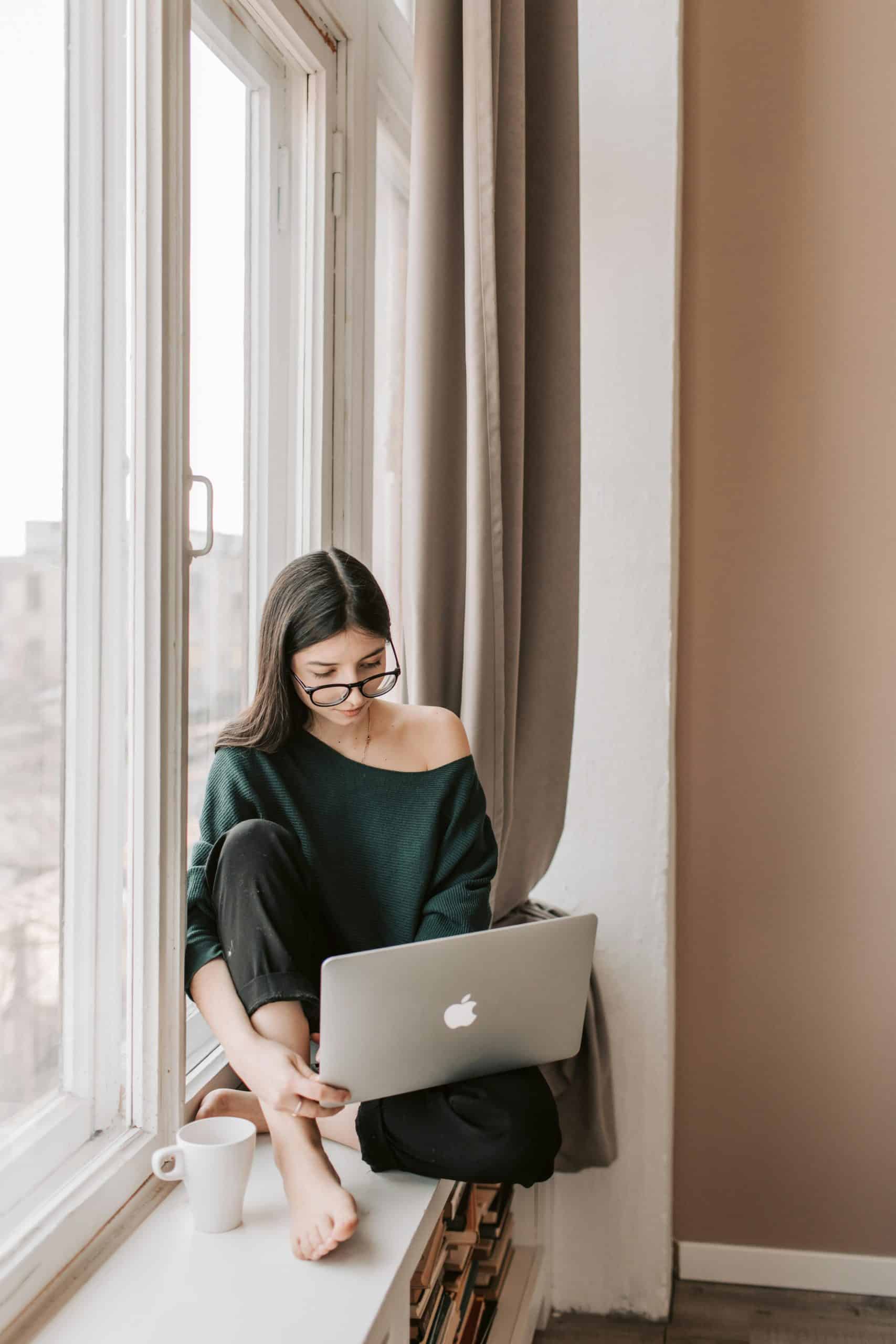 Young busy woman working from home in sweatpants