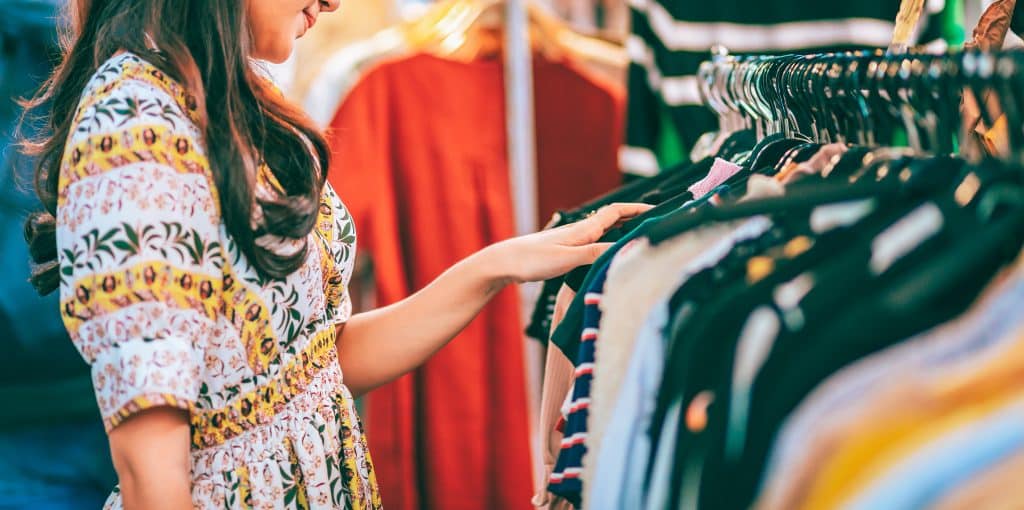 Woman looking through a clothing rack