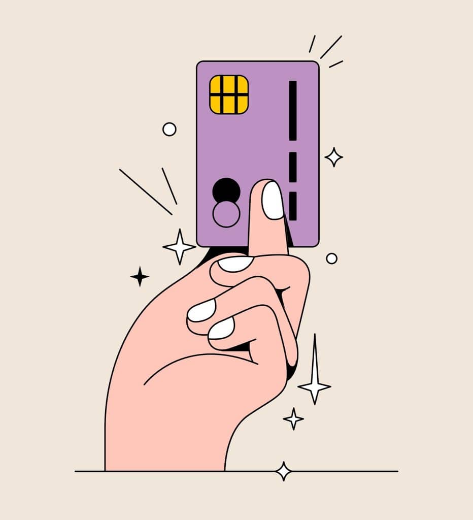 A hand holding up some form of payment card.