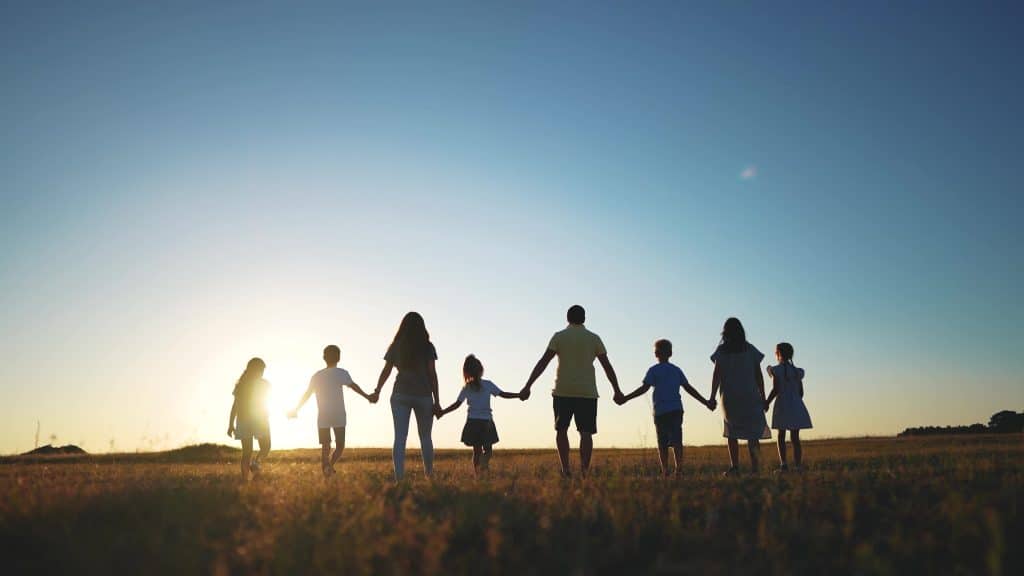 family posing on the beach